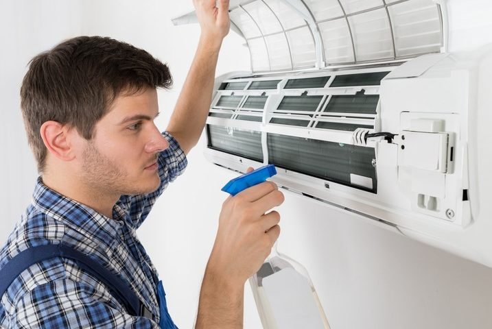 Professional HVAC engineer repairing air conditioner indoors | Icebolt Electrical